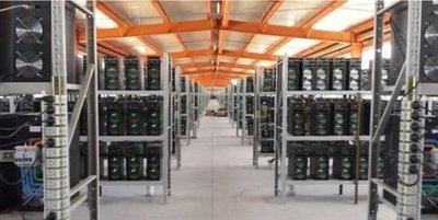 A large-scale bitcoin mining farm with rows of ASIC miners.
