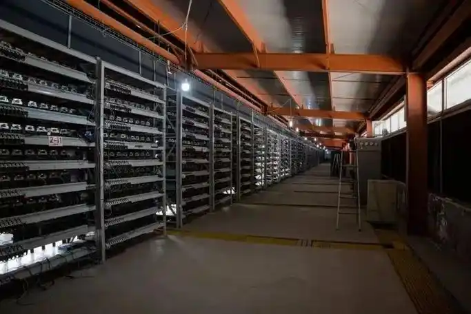 An aerial view of a sprawling mining farm, showcasing the scale and security measures in place.