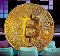 Bitcoin logo displayed on a screen alongside cryptocurrency mining hardware